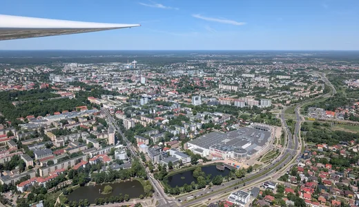A wing over a town seen from a few thousand feet