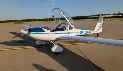 A motor glider on the apron in late afternoon light