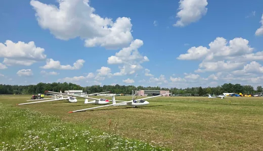 Gliders lined up on the grid under a cumulus sky