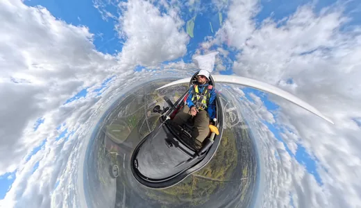 A 360 shot curled into a small planet, the pilot at its centre